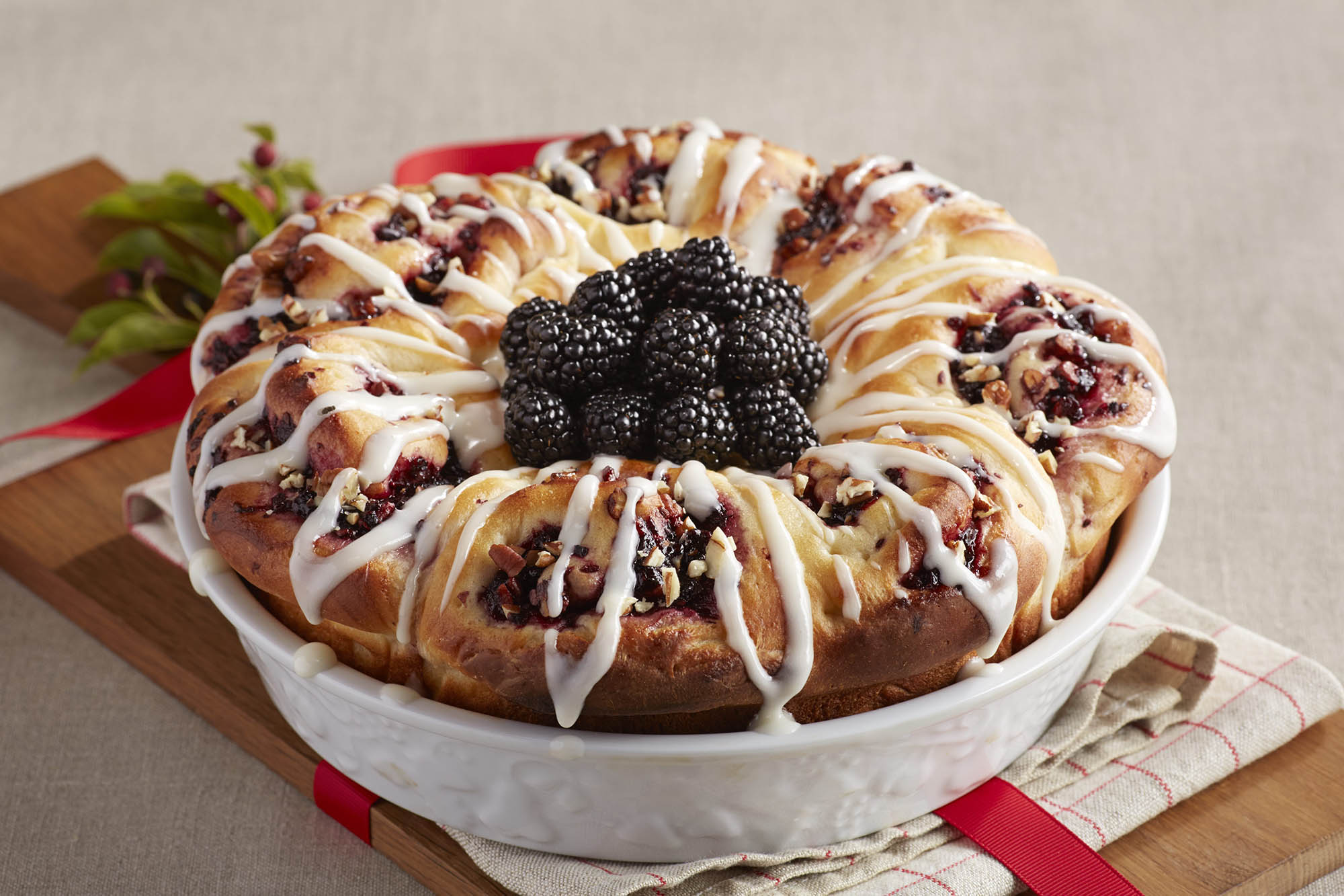 A bowl with blackberry pecan cinnamon rolls