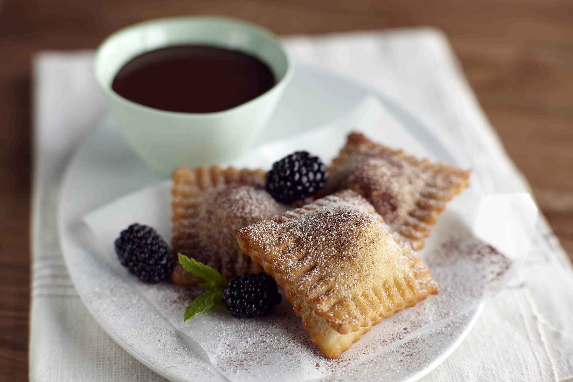 Plate of fried blackberry ravioli with chocolate fondue