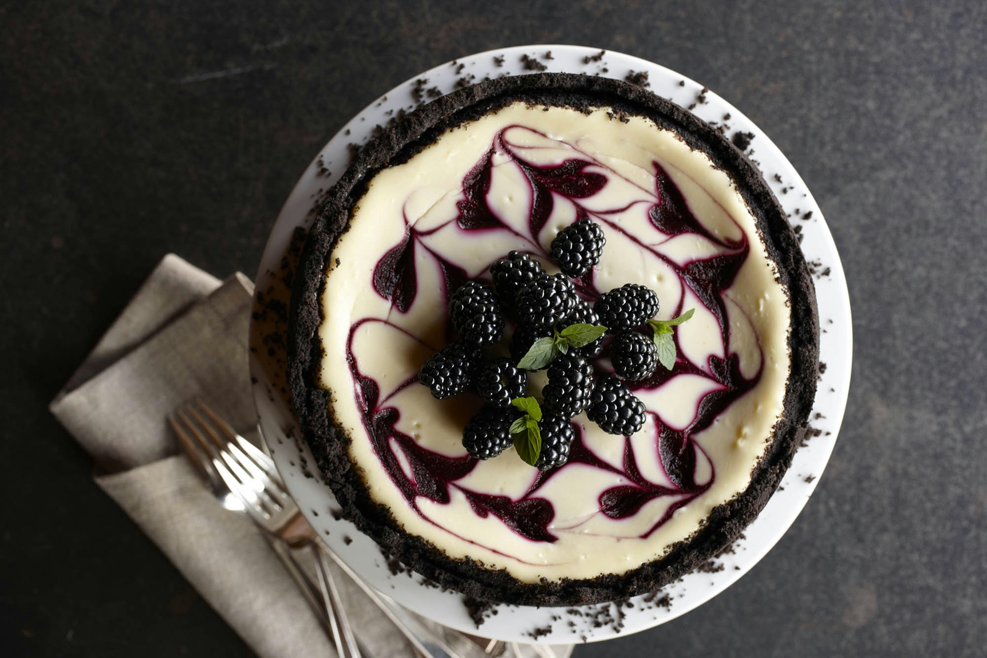 Swirled blackberry cheesecake with blackberries on top